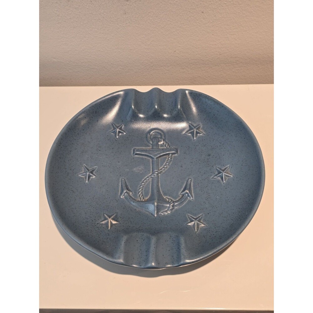 This is a vintage blue Chatham Pottery nautical ashtray featuring a central...
